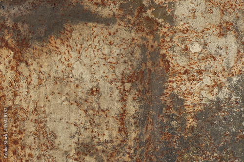 rusty metal surface with  beige, black, gray, yellow and orange tones - worn irregular steampunk background with scratches and peeling paint looking like a creepy map © Domingo