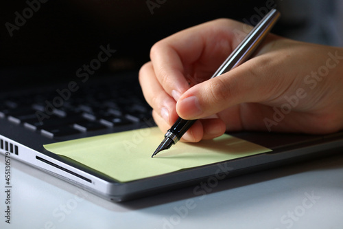 Business woman holding pens and papers making notes in documents on the table, Close up beautiful hand handle pen not on paper note , business and education concept