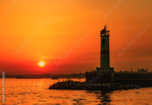 View to the lighthouse in sea of Marmara against colorful sunset sky