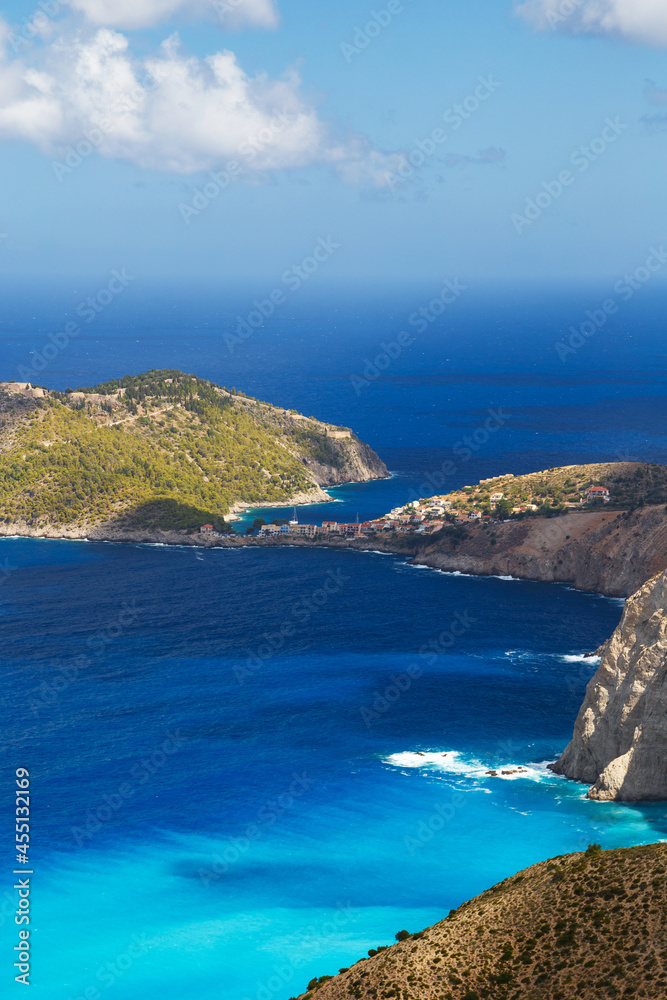 Aerial view at Asos village, Assos peninsula and fantastic turquoise and blue Ionian Sea water. Top view, summer scenery of famous and extremely popular travel destination in Cephalonia, Greece