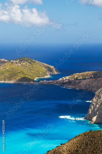 Aerial view at Asos village, Assos peninsula and fantastic turquoise and blue Ionian Sea water. Top view, summer scenery of famous and extremely popular travel destination in Cephalonia, Greece