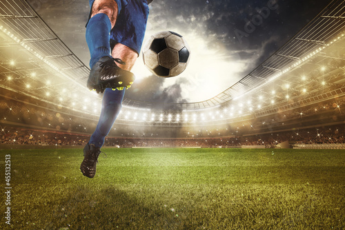 Close up of a striker who kicks the ball to make goals at the stadium during a soccer game