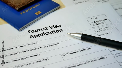  tourist visa application form with passport and pen document with passp photo