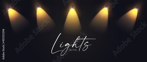 Shining gold spotlights on black. Glittering abstract background