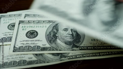 us money bills fall on brown wooden table cash profits or savings conce