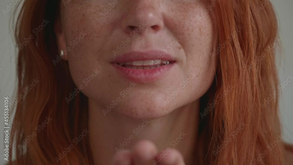 Beautiful young woman with red hair blow a kiss . Shows different emotions Beautiful young woman with red hair blow a kiss . Shows different emotions