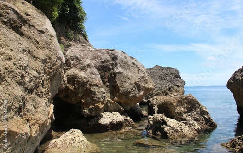 Fototapeta Naklejka Na Ścianę i Meble -  Big volcanic rocks in Sinandigan beach, diving spot in Puerto Galera, Oriental Mindoro