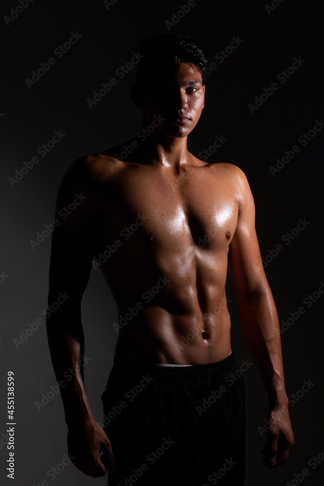 Fototapeta premium Latin and muscular man posing shirtless. strong and dark skinned man.