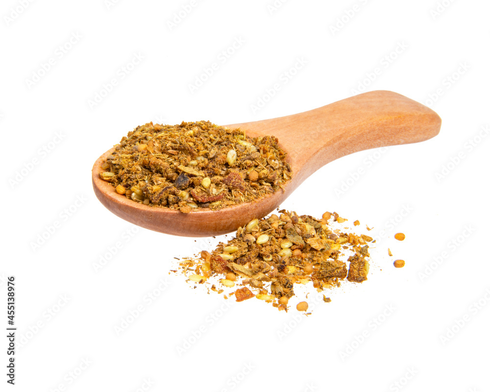 Dried aromatic spices in wooden spoon isolated on the white background Dried aromatic spices in wooden spoon isolated on the white background