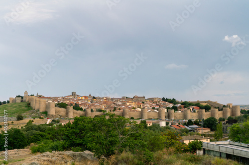 Panoramic view of the historic city of Avila, Spain, with its famous medieval walls surrounding the city at sunset. Called City of Stones and Saints