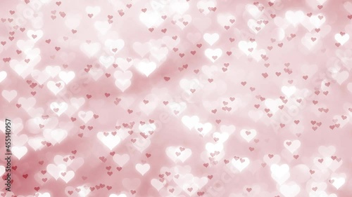 Large group of small red heart shapes on a Valenitines day bokeh motion background.	