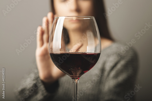 reject liquor,stop alcohol, teenager girl shows a sign of refusal of wine photo