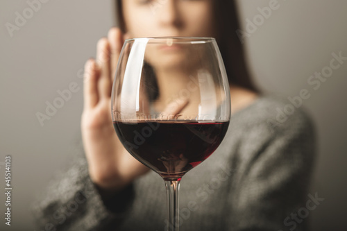 Wall Mural reject liquor,stop alcohol, teenager girl shows a sign of refusal of wine
