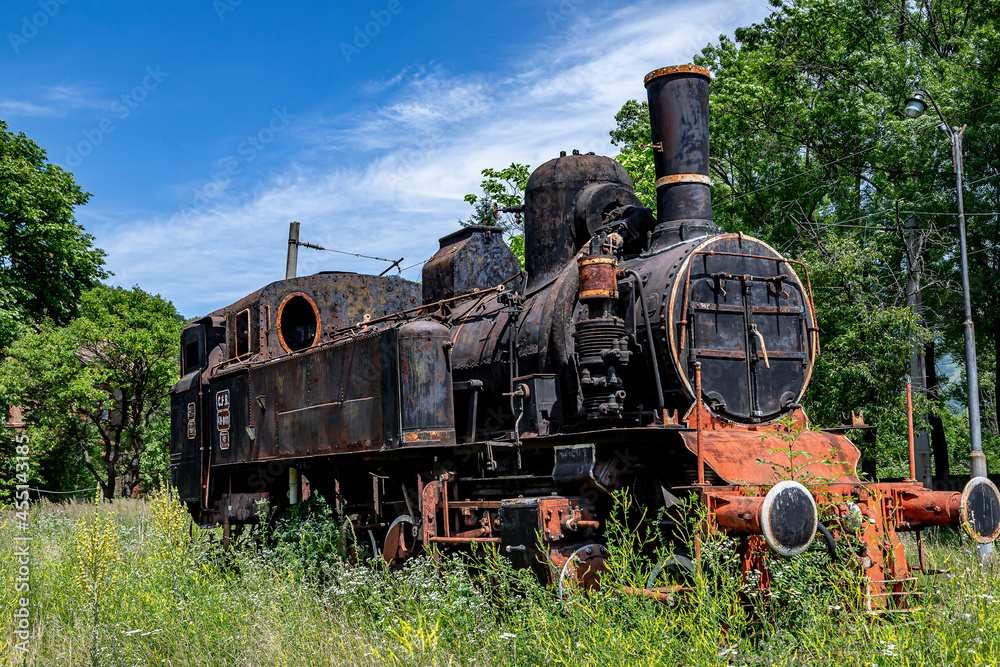  The old steam locomotive is parked in a depot 
