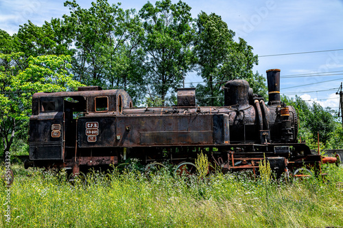  The old steam locomotive is parked in a depot 