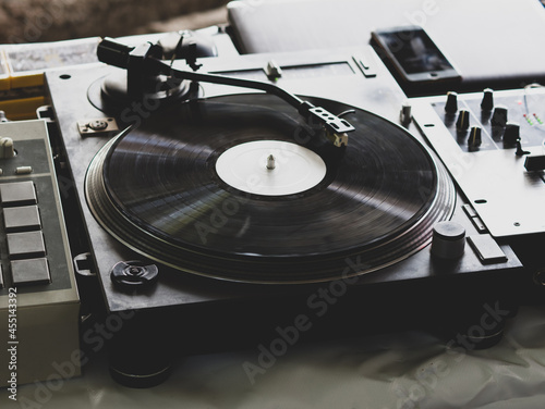 DJ playing music at a hip hop party. analog turntable, Dj uses turntable and mixer for scratching.