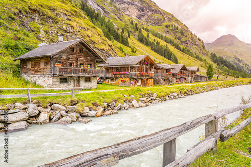 Old rural wooden houses in Innergschlos village, Gschlosstal Valley in Hohe Tauern National Park, East Tyrol, Austrian Alps photo