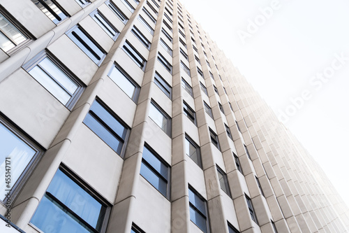 Very tall white building with glass windows in the city