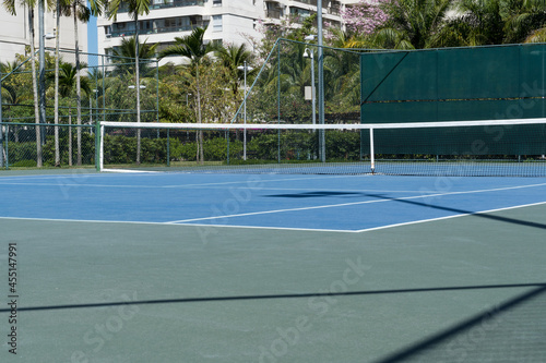 Wallpaper Mural Tennis court with blue floor. Perfect for practicing sport. Hard lighting. Selective focus. Torontodigital.ca