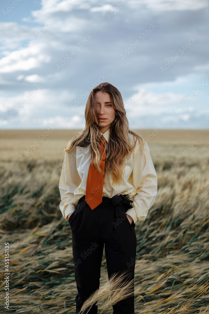 Stylish thoughtful model in wheat field under cloudy sky Stylish thoughtful model in wheat field under cloudy sky