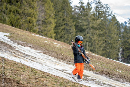 Photography Child holding ski and walking on grass