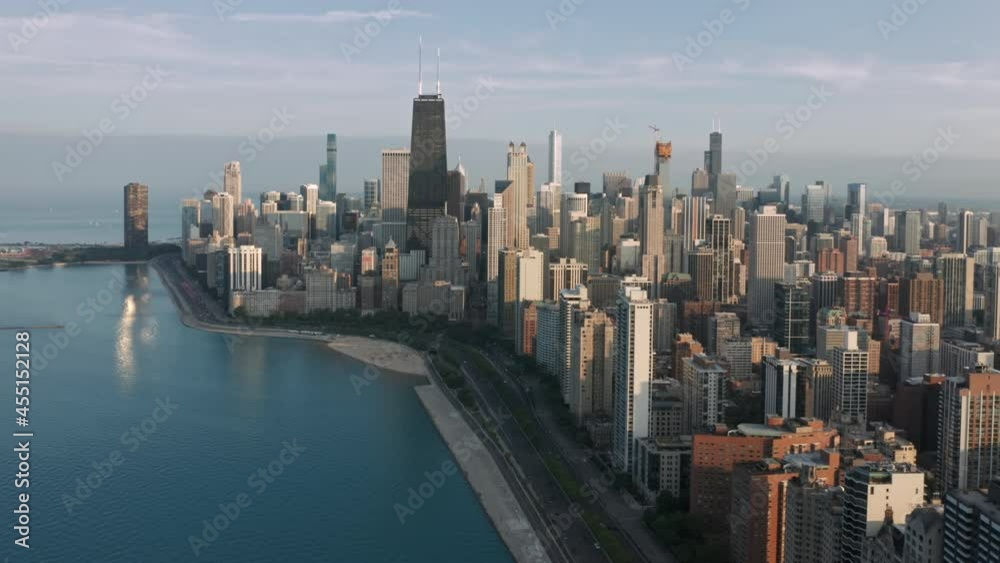 Breathtaking modern city coastline in golden sunset light. 4K aerial prestige apartments and business offices at Michigan lake shore. Epic Chicago cityscape, Illinois United States of America Breathtaking modern city coastline in golden sunset light. 4K aerial prestige apartments and business offices at Michigan lake shore. Epic Chicago cityscape, Illinois United States of America