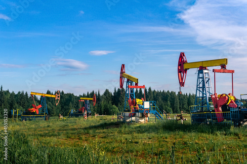 oil pumping stations pumpjacks in a clearing in the forest photo