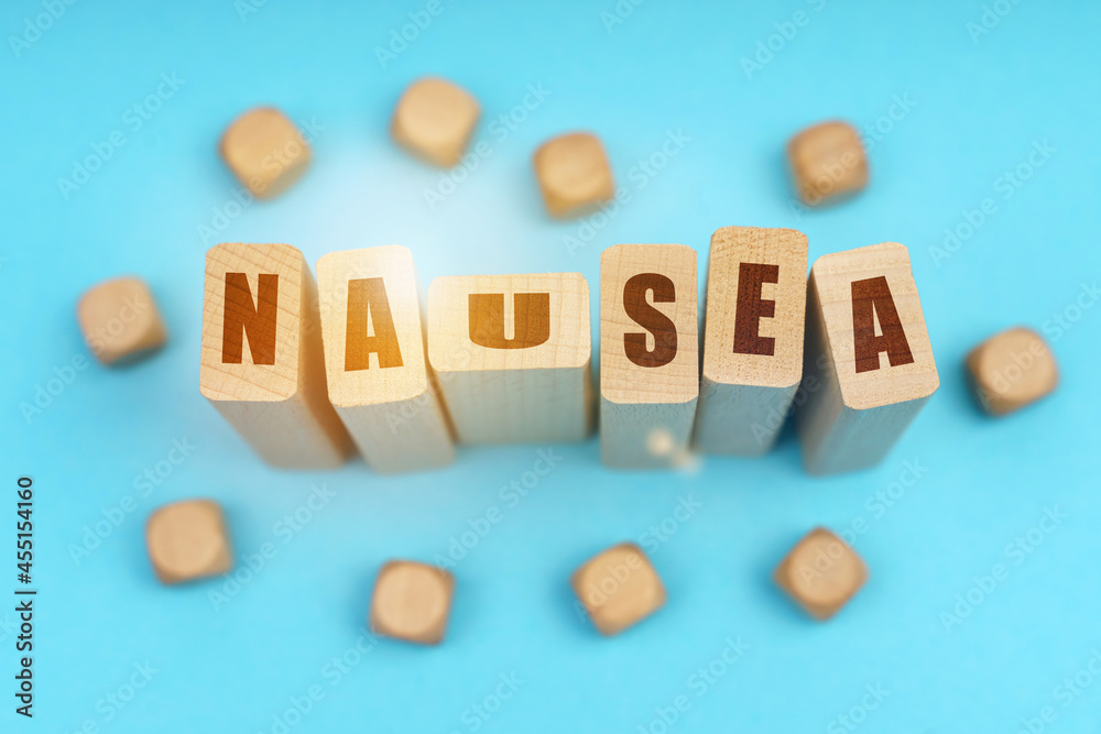 On a blue background, wooden cubes and Jenga with the inscription - NAUSEA On a blue background, wooden cubes and Jenga with the inscription - NAUSEA