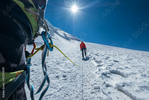 Tablou pe pânză Rope team ascending Mont Blanc (Monte Bianco) summit 4,808m dressed red mountain