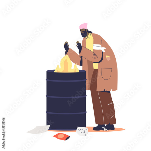 Homeless unemployed beggar warming at fire burning in trash metal can. Jobless tramp live outdoors