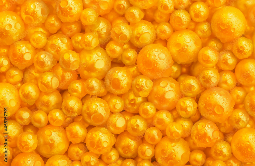 Beautiful background with pearl gold pearls, top view. Abstract texture for festive backgrounds. Shiny yellow surface of Christmas decorations. Gems close-up. Golden bright background. Beautiful background with pearl gold pearls, top view. Abstract texture for festive backgrounds. Shiny yellow surface of Christmas decorations. Gems close-up. Golden bright background.