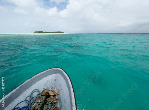 Shallow atoll turquoise waves around Mnemba island in the Indian ocean near the Zanzibar island, Tanzania. Exotic countries traveling concept image. photo