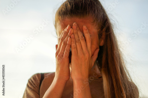 the girl covered her face with her hands