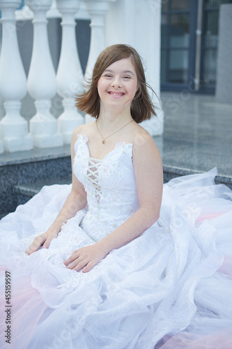 Girl with Down syndrome in  wedding dress.