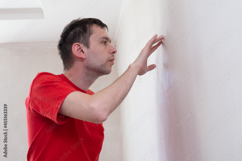 Man repair worker checking or inspection the level and appearance of wall in the building. Renovation apartment concept. Man repair worker checking or inspection the level and appearance of wall in the building. Renovation apartment concept.