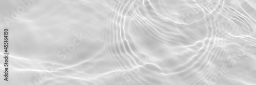 Water texture with sun reflections on the water overlay effect for photo or mockup. Organic light gray drop shadow caustic effect with wave refraction of light. Long banner with empty space.
