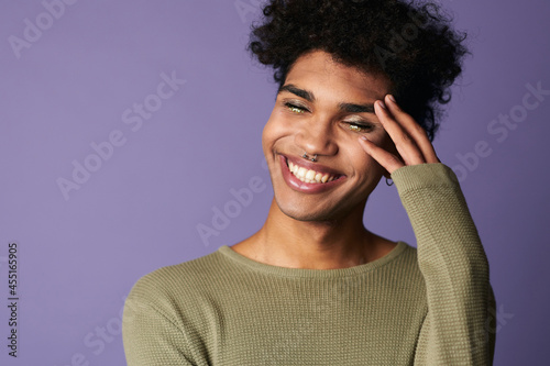 Close-up african american male smile with afro hairstyle. Portrait of handsome transgender young man photo