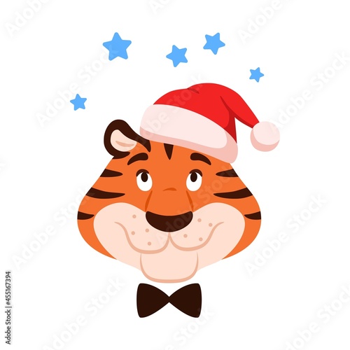 Cute smiling cartoon tiger head isolated on white background. Flat happy character in Santa hat with stars. Chinese New Year dreaming symbol. Comic striped wildcat face. Christmas vector illustration. © julkirio