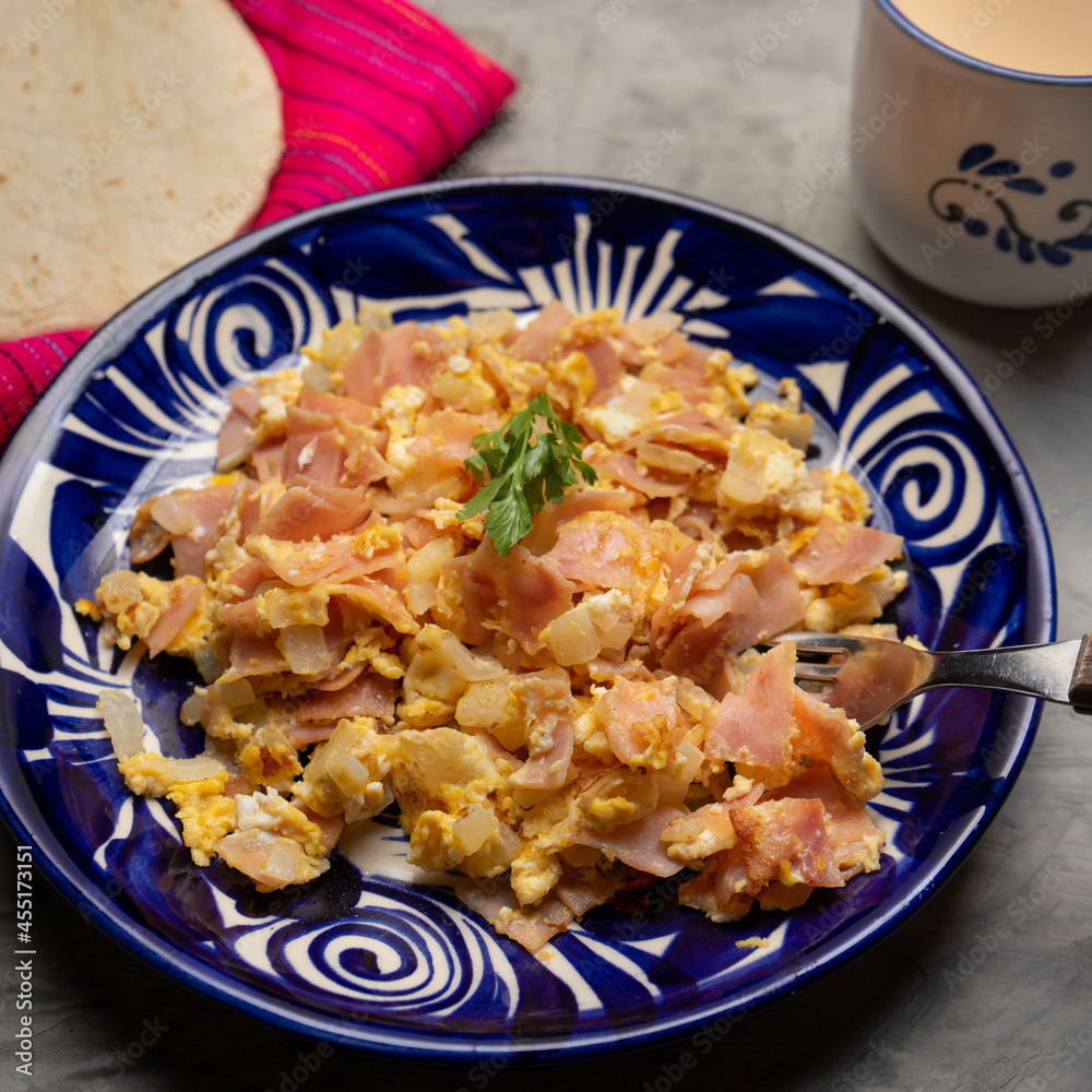 Scrambled eggs with ham for breakfast on grey background Scrambled eggs with ham for breakfast on grey background