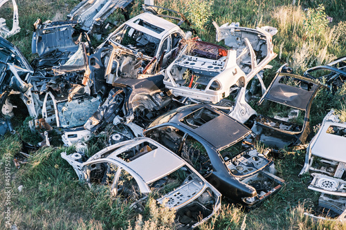Car dump. A bunch of old rotten broken cars in the field. Top view