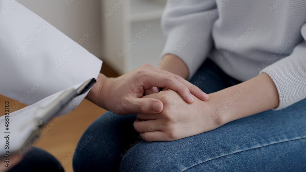 Fototapeta premium Close-up hand asia people female sit talk sharing sad tension, life issue medical advice meeting, sick woman rehab consult with doctor give help warm touch relief, unhappy serious hopeless emotion.