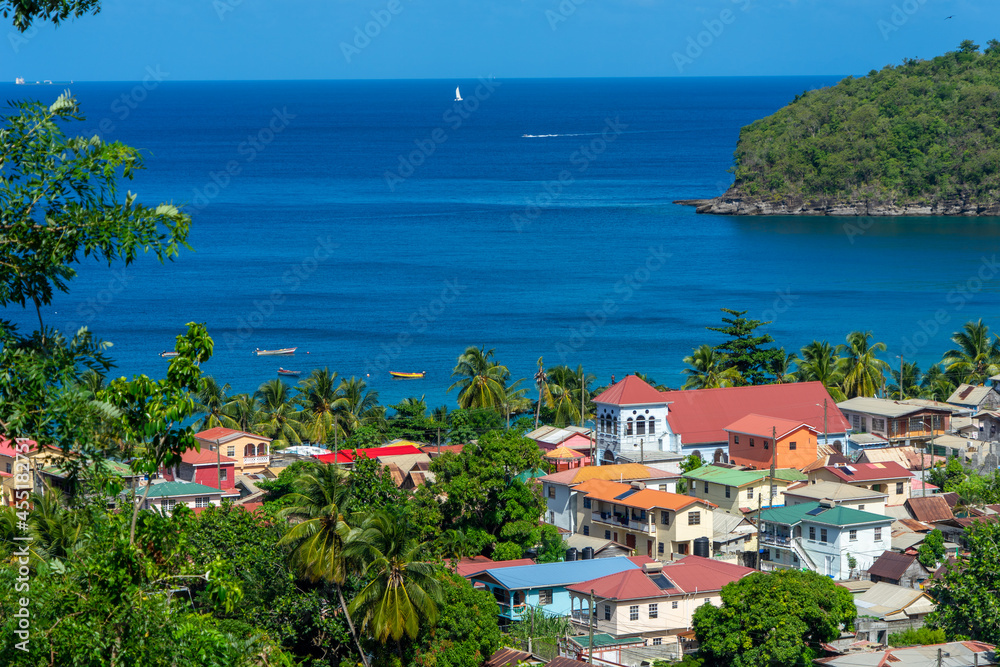 Small fishing village on St Lucia.  Caribbean colored houses and bay.