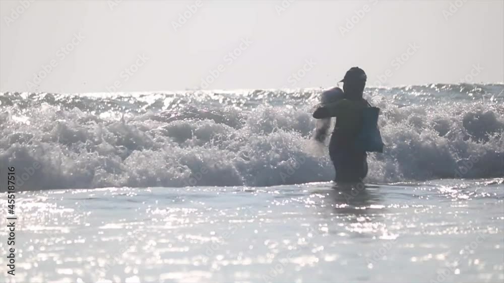 Fisherman catching fish in struggling with waves at bay of bengal,Indian ocean Fisherman catching fish in struggling with waves at bay of bengal,Indian ocean