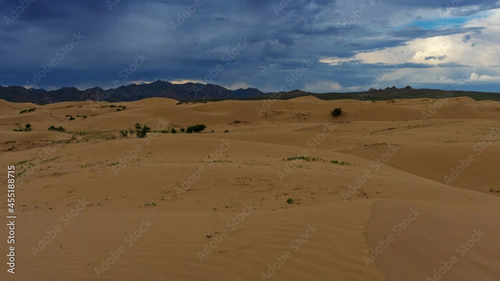 Sand dunes with storm clouds at sunset in Gobi Desert, Mongolia, panorama timelapse 4k Sand dunes with storm clouds at sunset in Gobi Desert, Mongolia, panorama timelapse 4k
