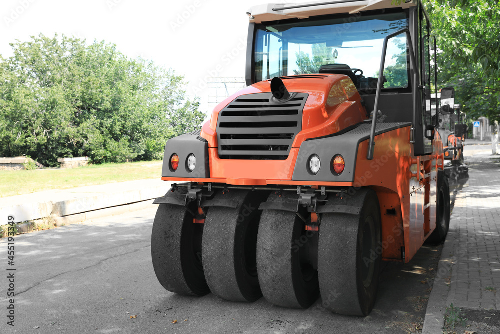 Modern roller on city street. Road repair service Modern roller on city street. Road repair service
