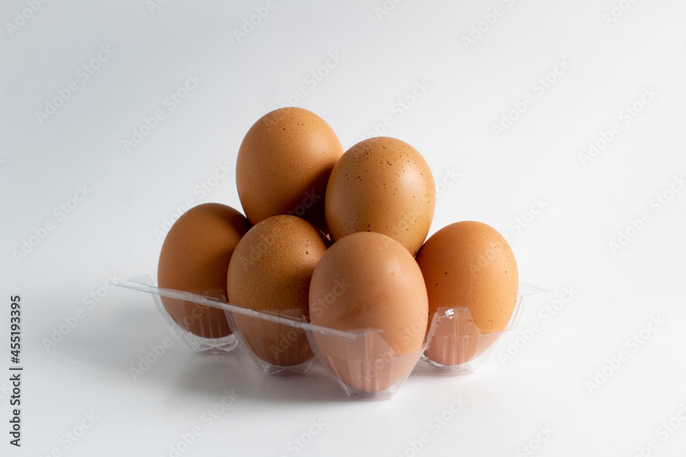 Some eggs and egg holder on white background Some eggs and egg holder on white background