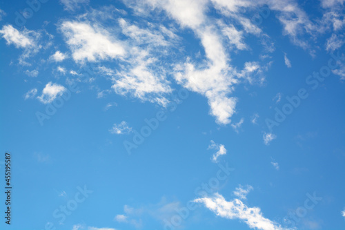 Horizontal view with white small clouds against blue sky