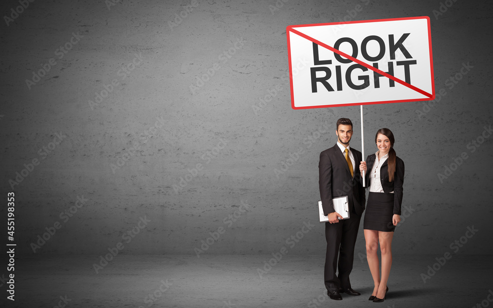 business person holding a traffic sign business person holding a traffic sign