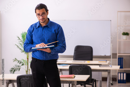 Young male teacher in front of whiteboard