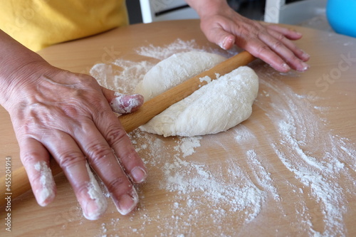 Process of making a traditional Turkish dough is called "Borek", selective focus. It is called "Kol Boregi" in Turkish. Round pie with cheese, spinach, greased with yolk. Delicious Balkan pie.